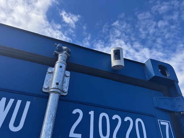 CCTV security camera mounted on blue shipping container demonstrating security monitoring at Benton Storage
